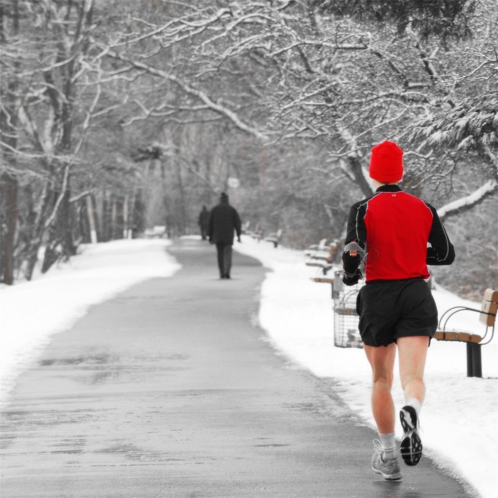 Tips For Running in the Winter - man running in snow on path