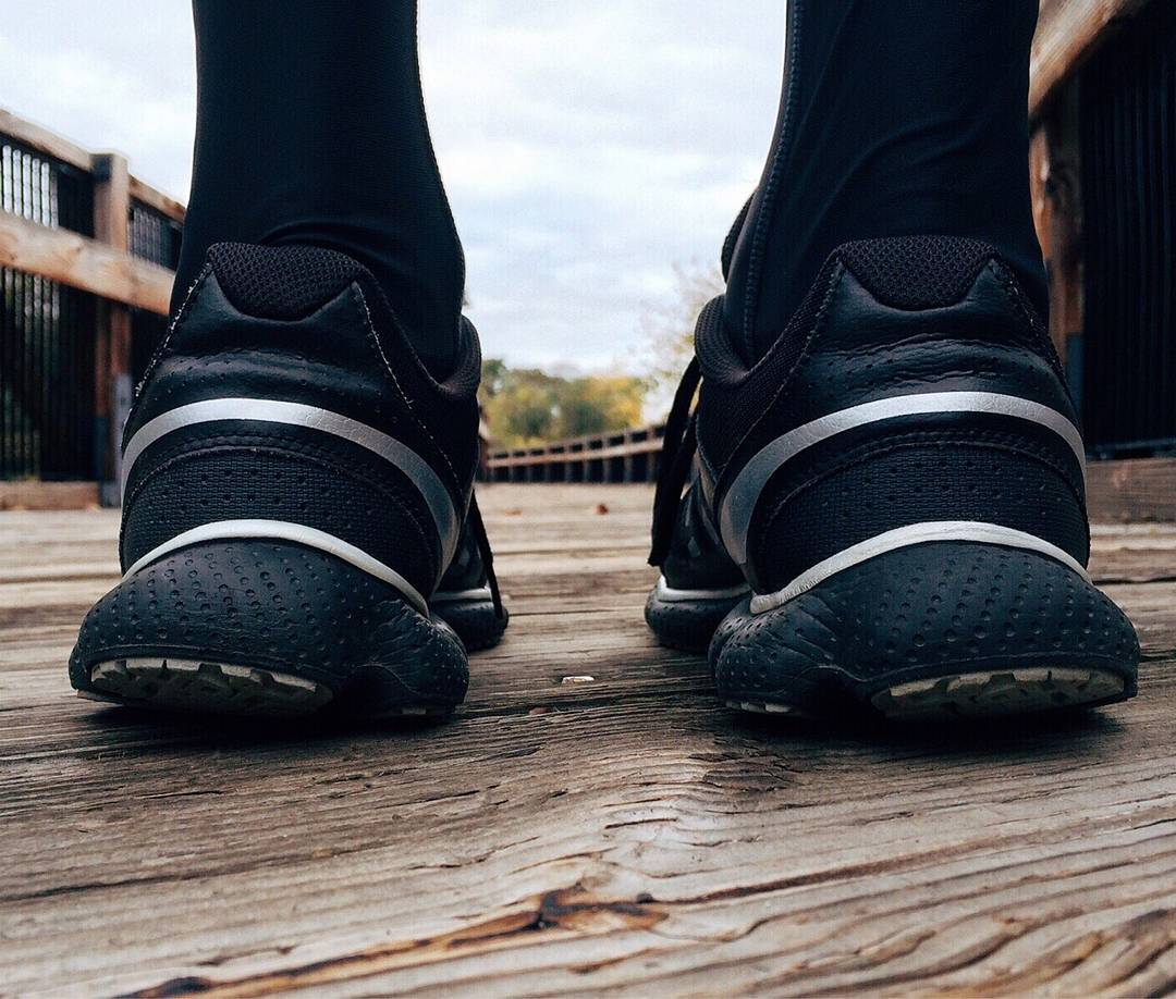 pair of running trainers from the back on wooden boardwalk close-up