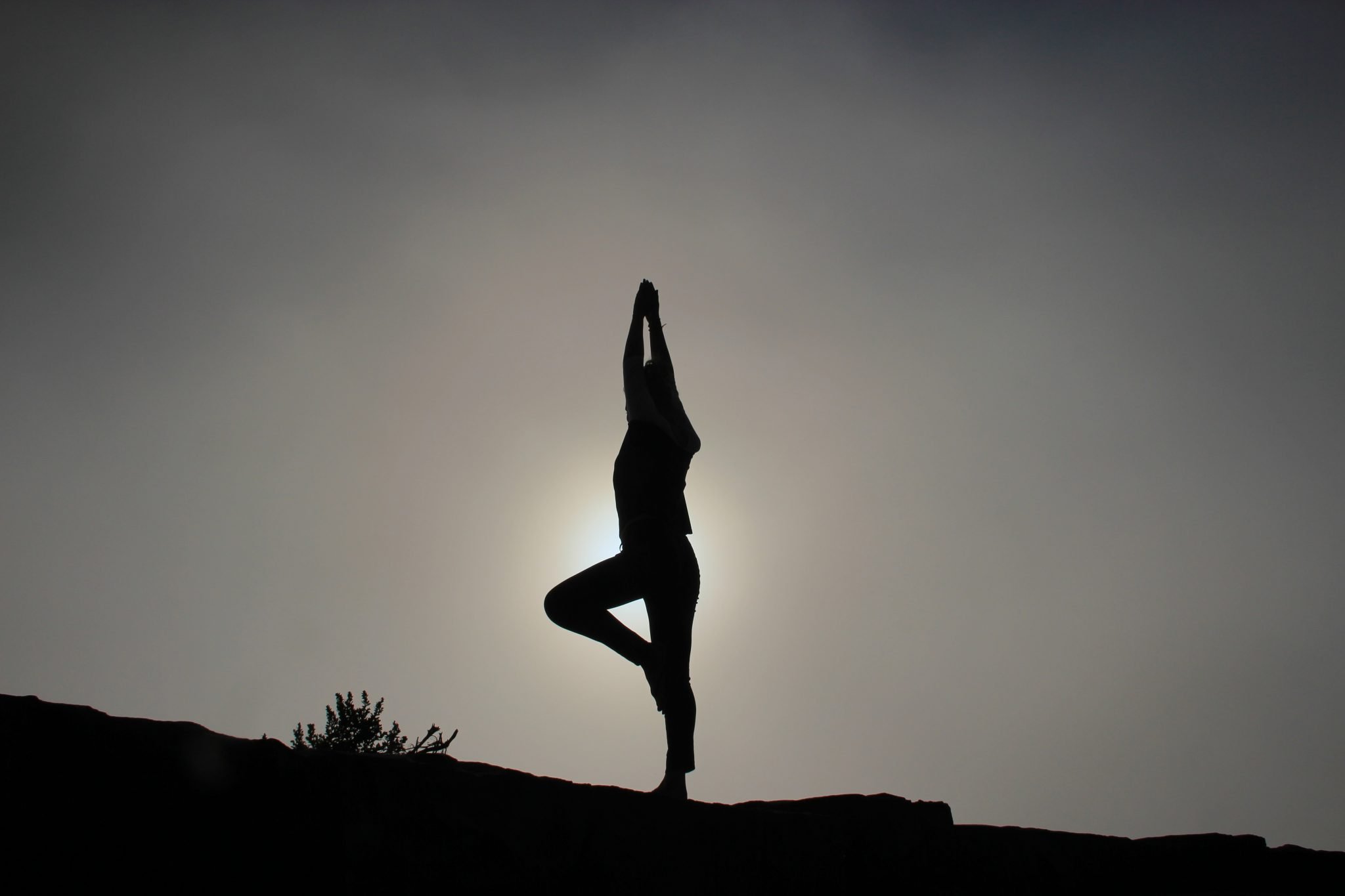 silhouette of a lady doing yoga